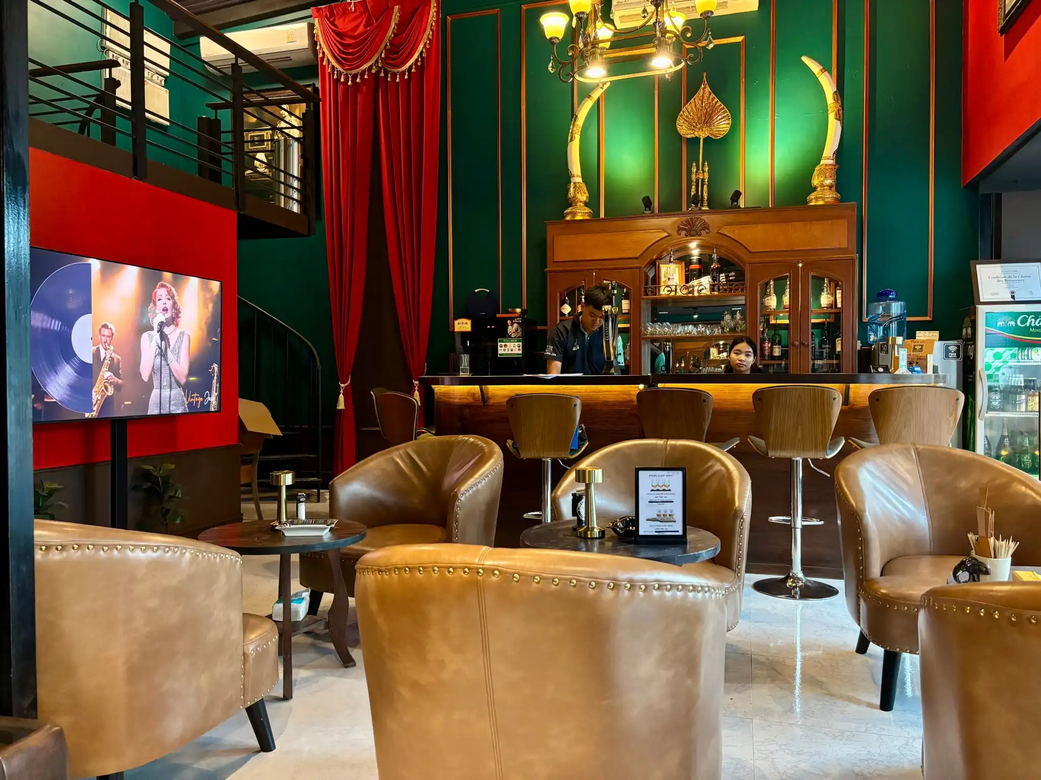 Green velvet seating in the CNX Cigars lounge